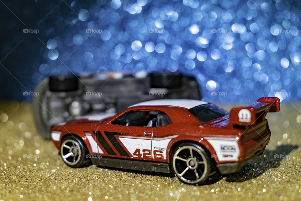 red car in a race. a black car overturned.