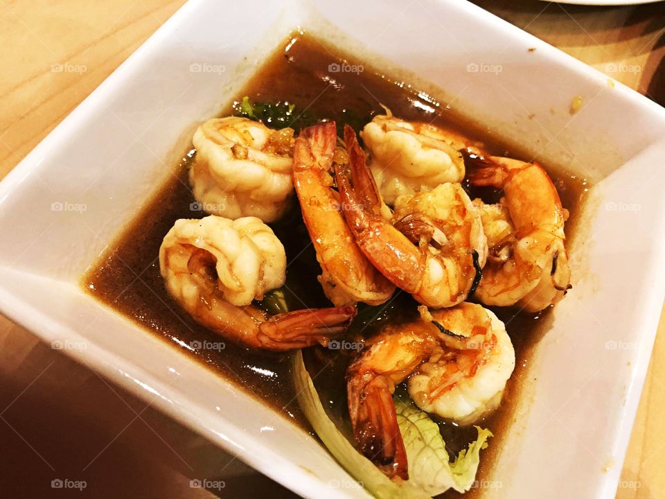 Tasty marinated shrimp with veggies and sauce.