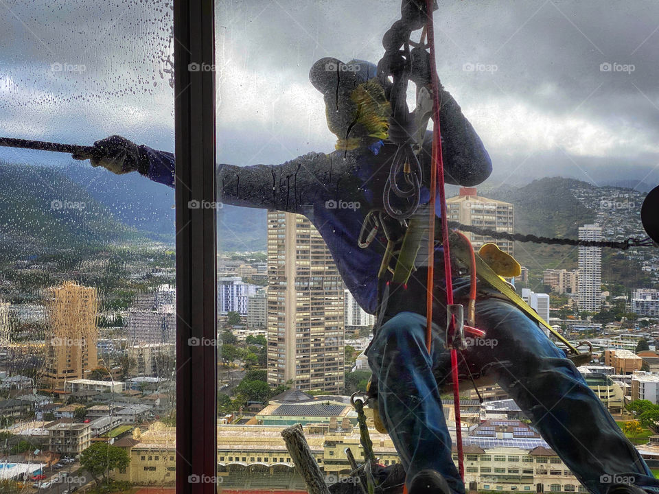 Window washer working on a high-rise building’s windows