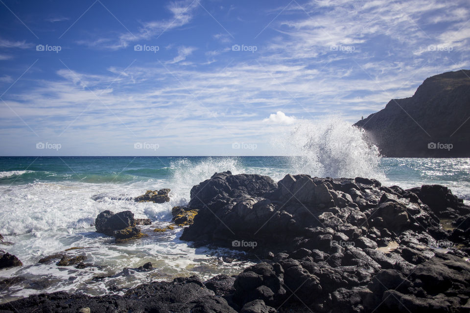 Waves crash on a rocky Hawaiian coast