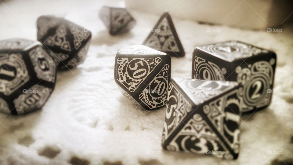 Staying in good shape roll playing game dice on a table in the sunlight