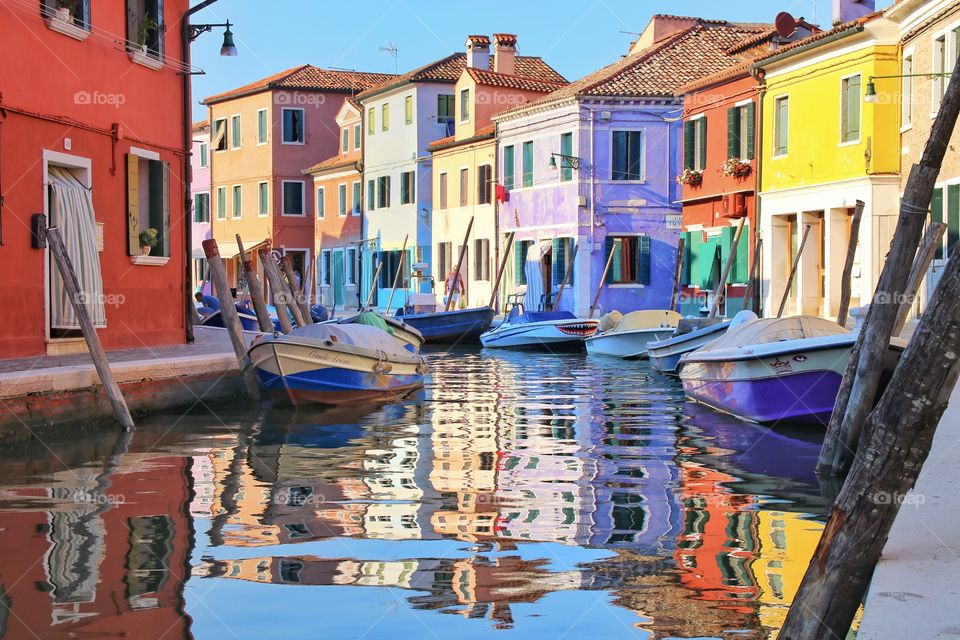 Reflection in the river with boats of colorful houses