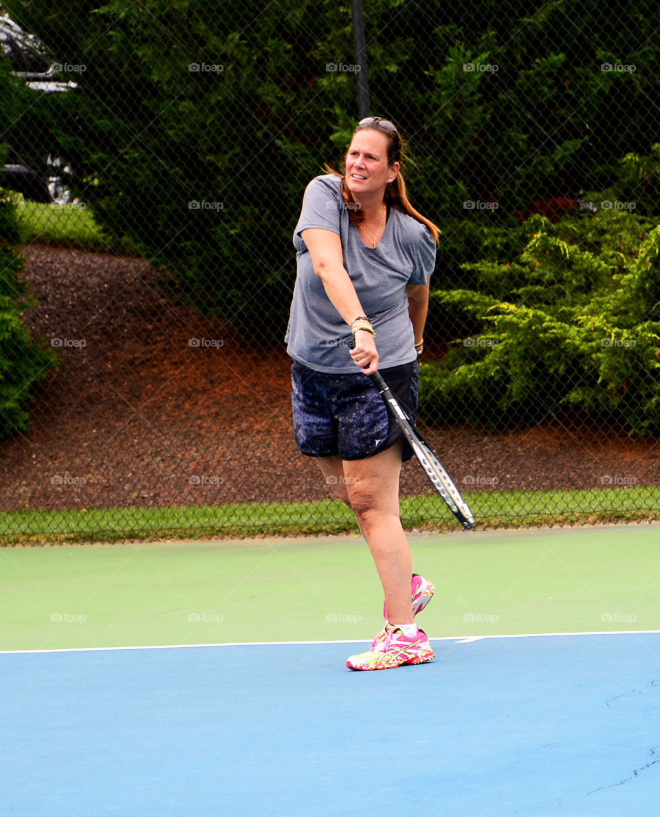 Mature woman playing tennis