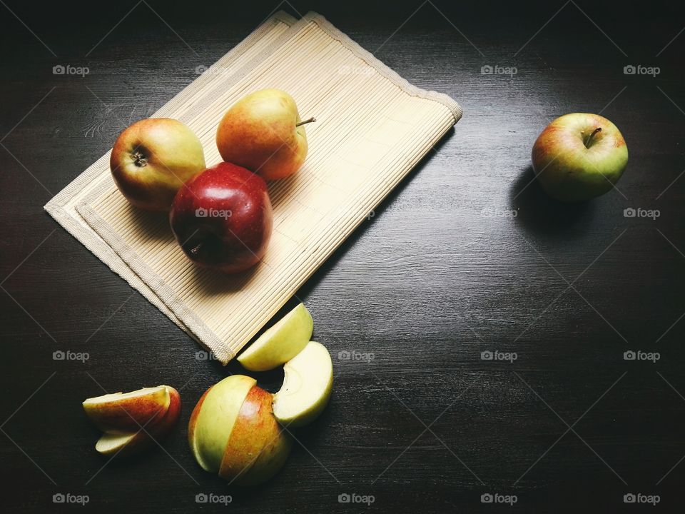 Apple and sliced apples on table