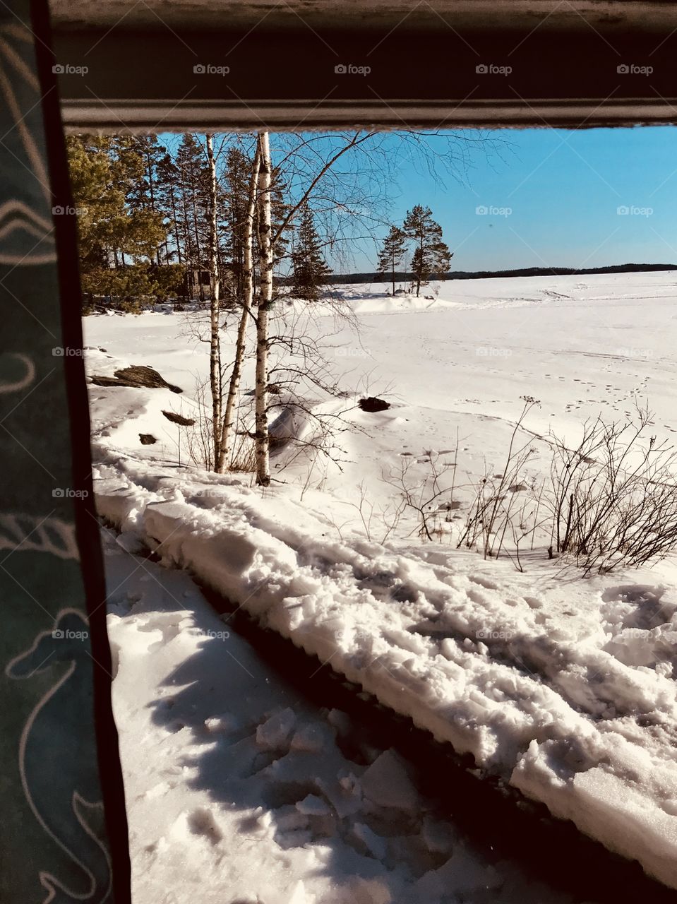 A view from a window to a snowy sunny day 