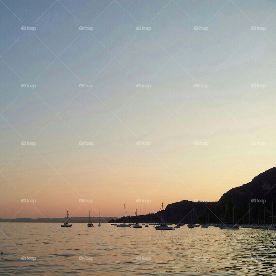 sunset boats lake garda by dperkins