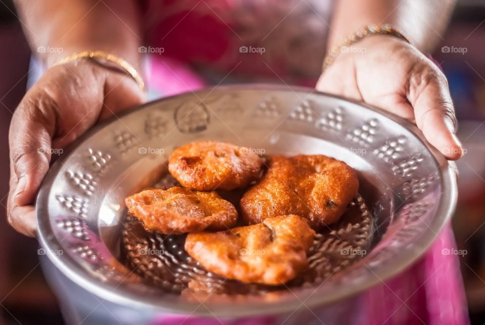 Woman holding plate of snacks in hand