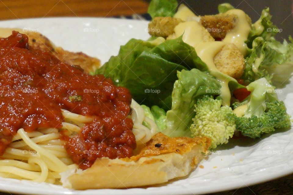 Closeup of salad and pasta dinner