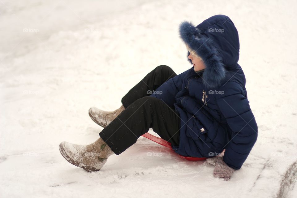 Girl reading a book in bed under the Christmas tree