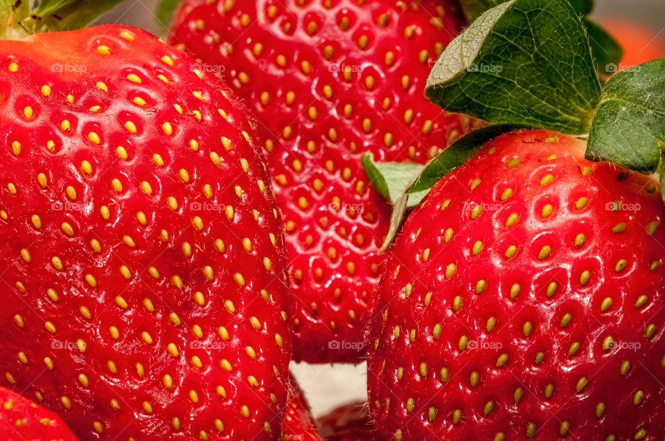 Macro view of some strawberries in high resolution, featuring detailed structures