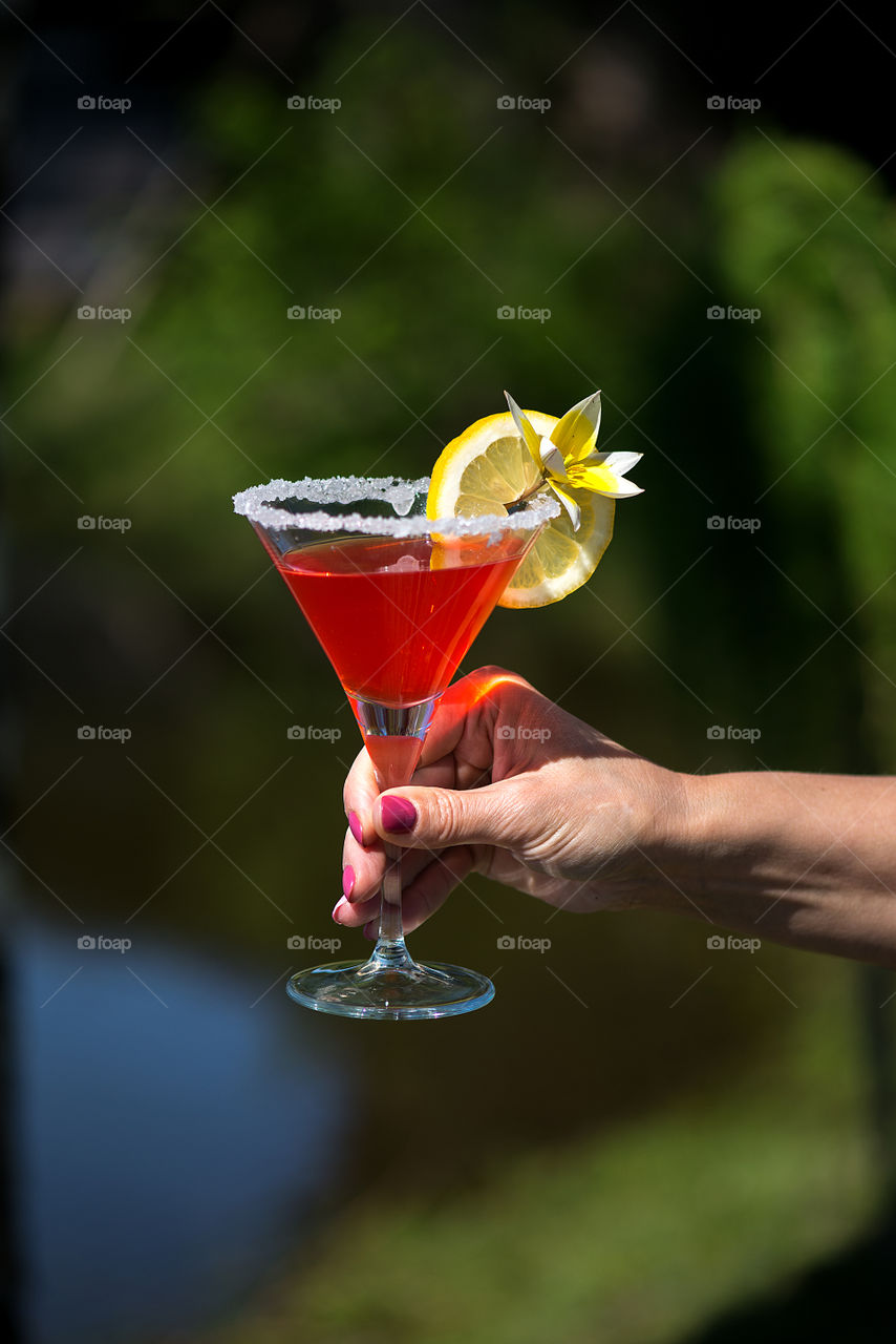 Close up of hand with cocktail glass