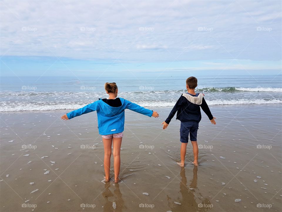 a girl and a boy by the sea