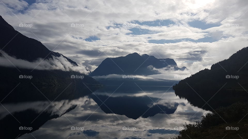 Reflection of the fjord in the water. Norway.