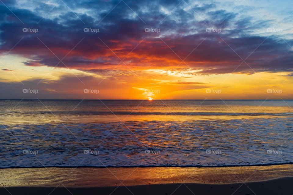 Sun rise with clouds creating magical colours. Perfect summer morning in Trincomalee, Sri Lanka.