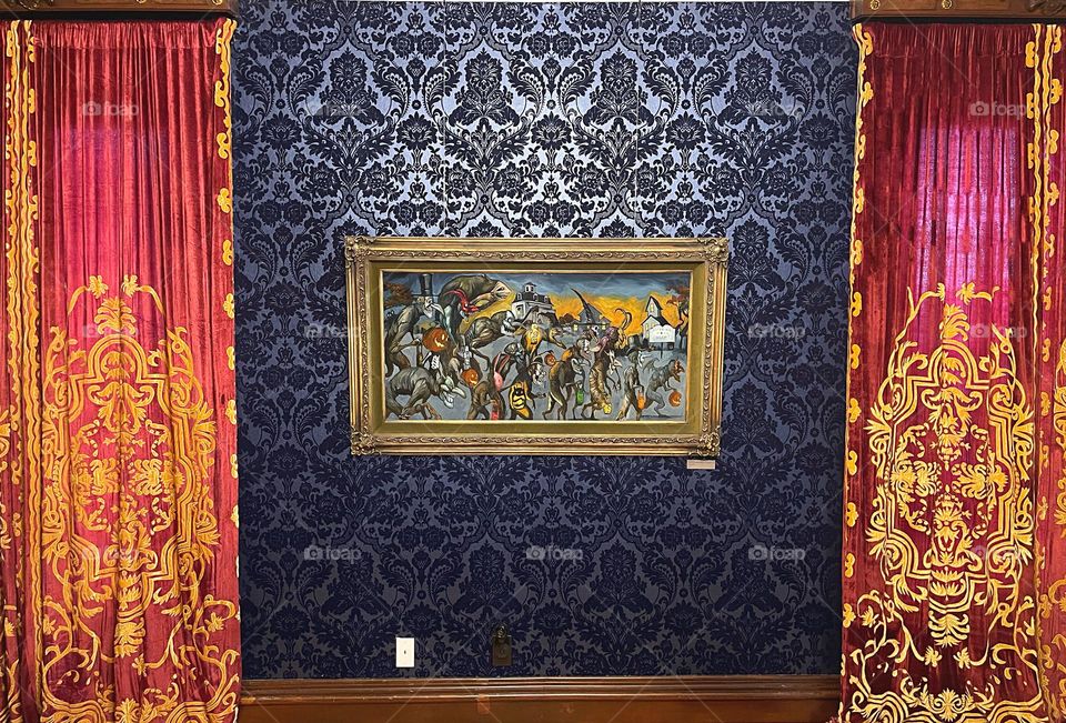 Painting on wallpapered wall with drapes 