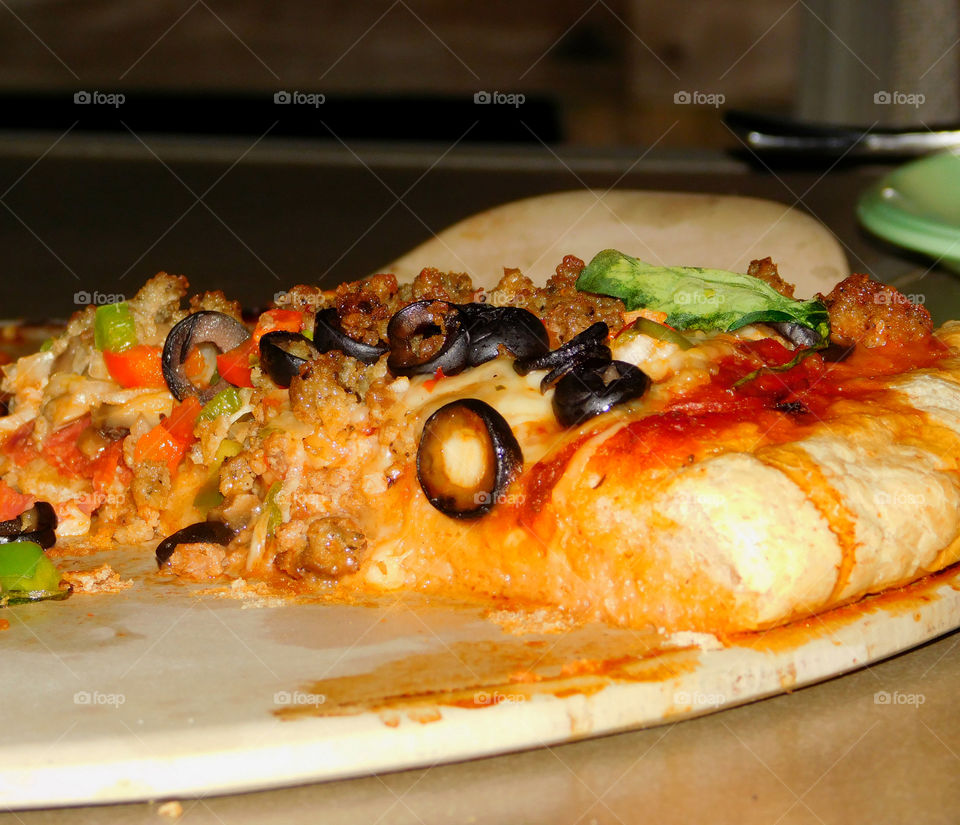 Delicious and nutritious homemade pizza with fresh, colorful vegetables, meats and a variety of spices! Grab a slice!