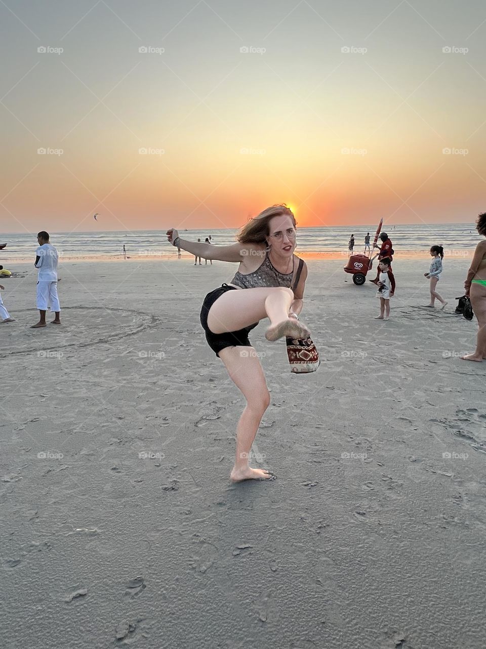 Woman in the beach at sunset 