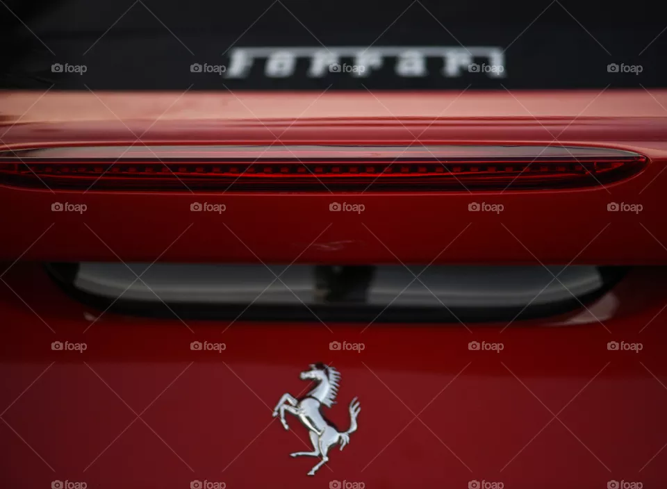 Back of a Ferrari race car and its logo