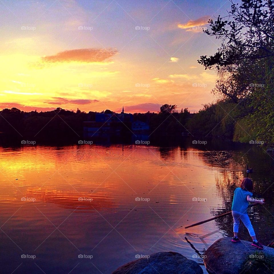 A kid enjoys the sunset 