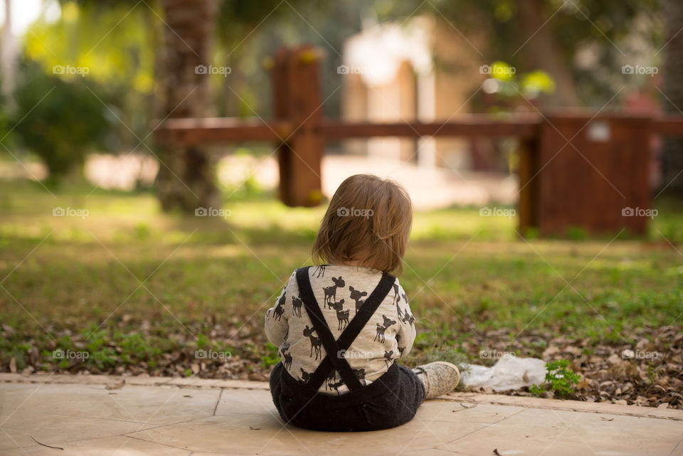 baby girl sitting enjoying outdoors