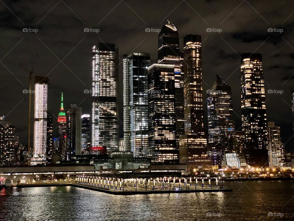 The New York City skyline at night viewed from the Hudson River