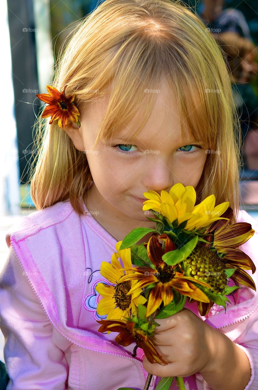 Spring flowers. Girl smelling spring flowers