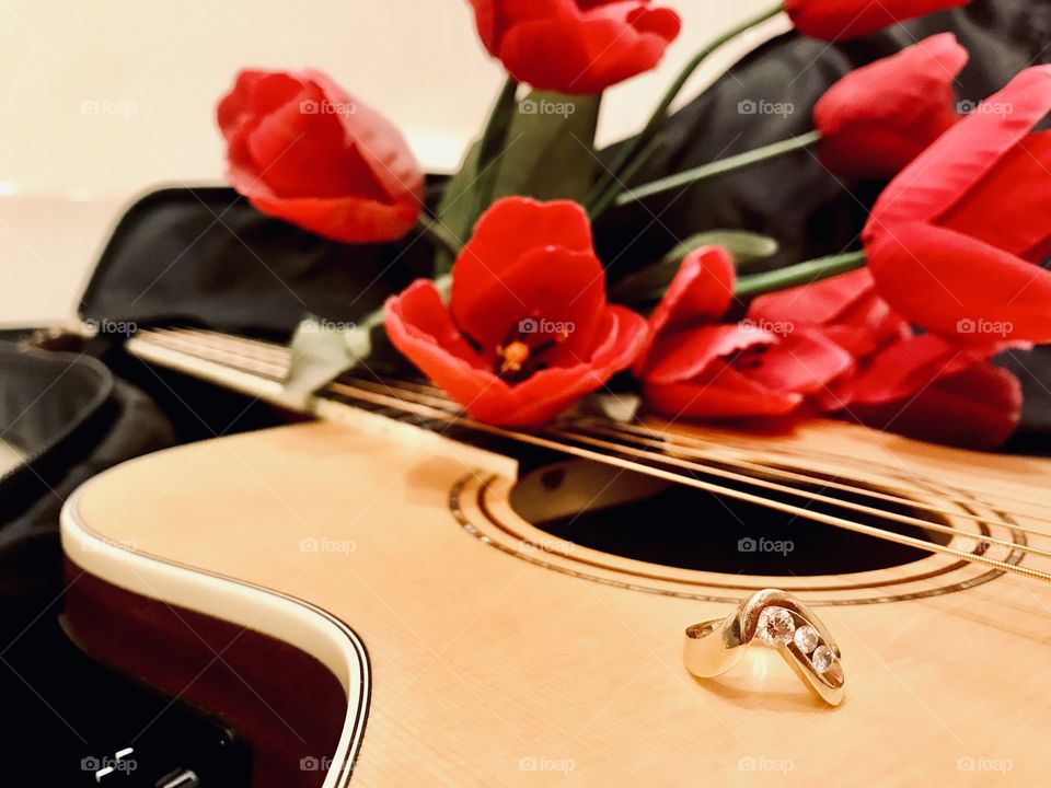 Fun photo of guitar with guitar case filled with books, money, and camera for trip! 