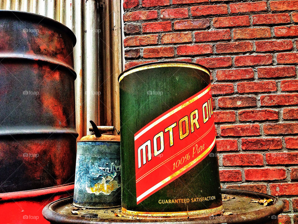Vintage American gas filling station with barrels of old motor oil