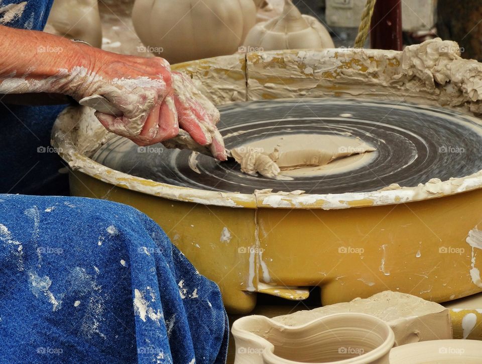 Shaping Clay On A Pottery Wheel