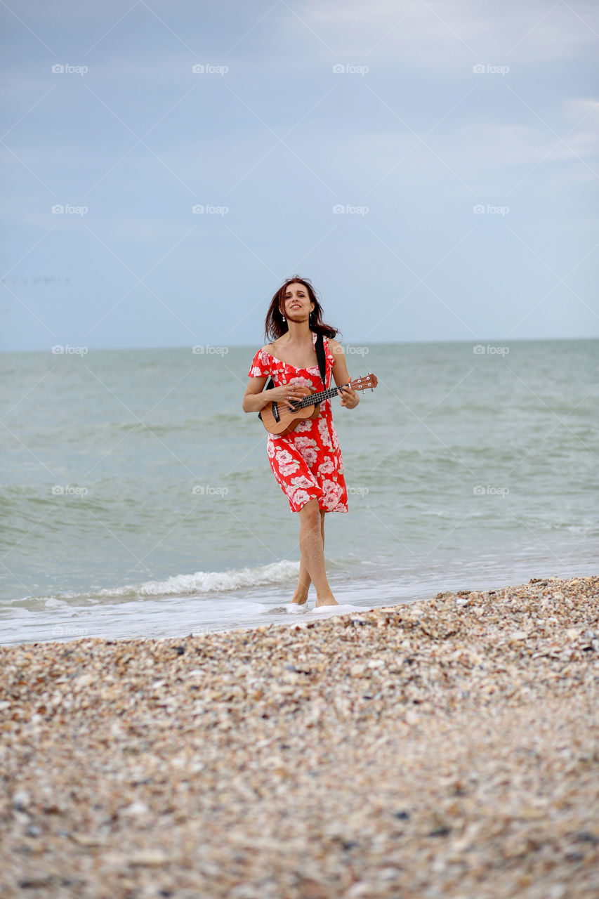 inspired girl plays and sings on ukulele