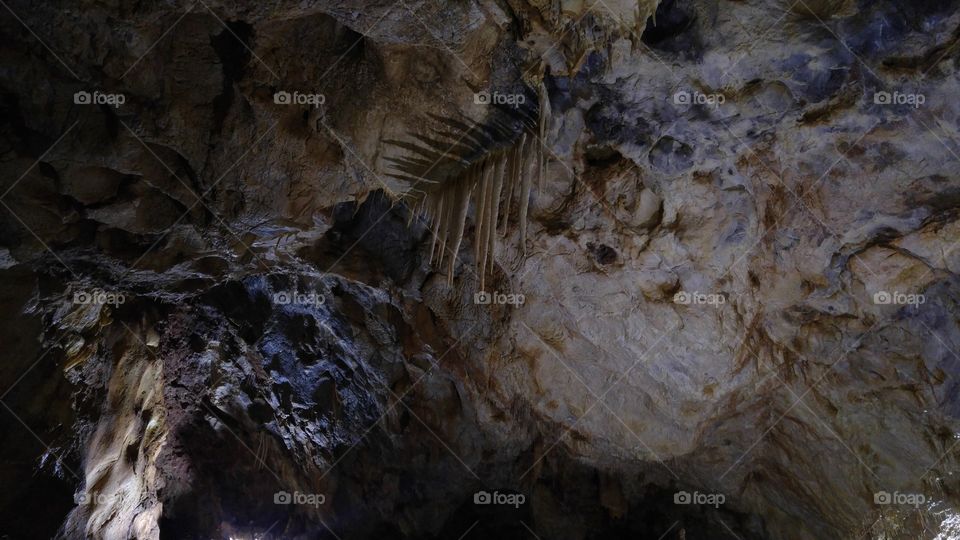 A dark underground cave in Romanian mountains