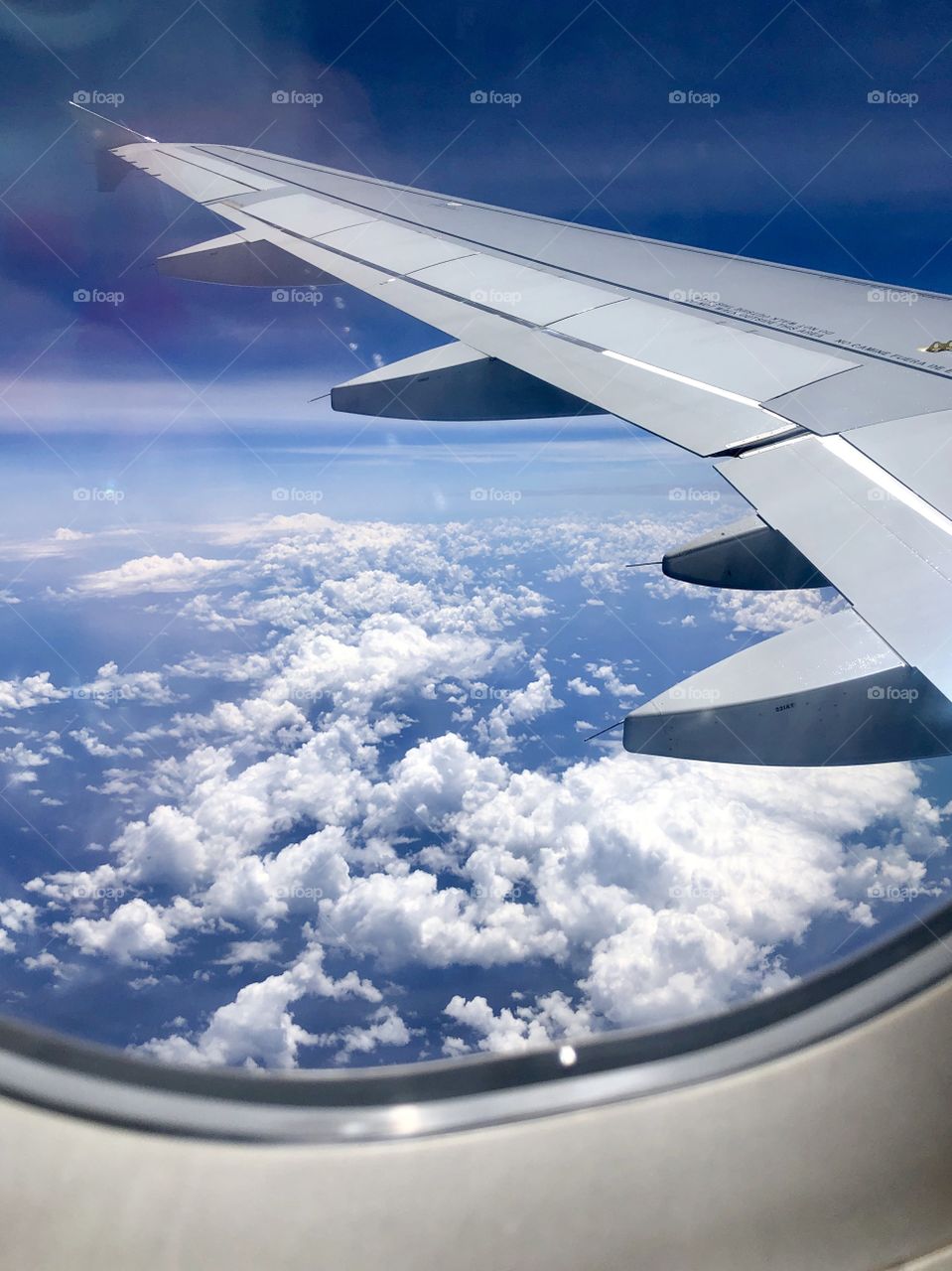 Flying height above beautiful puffy clouds over a blue sky