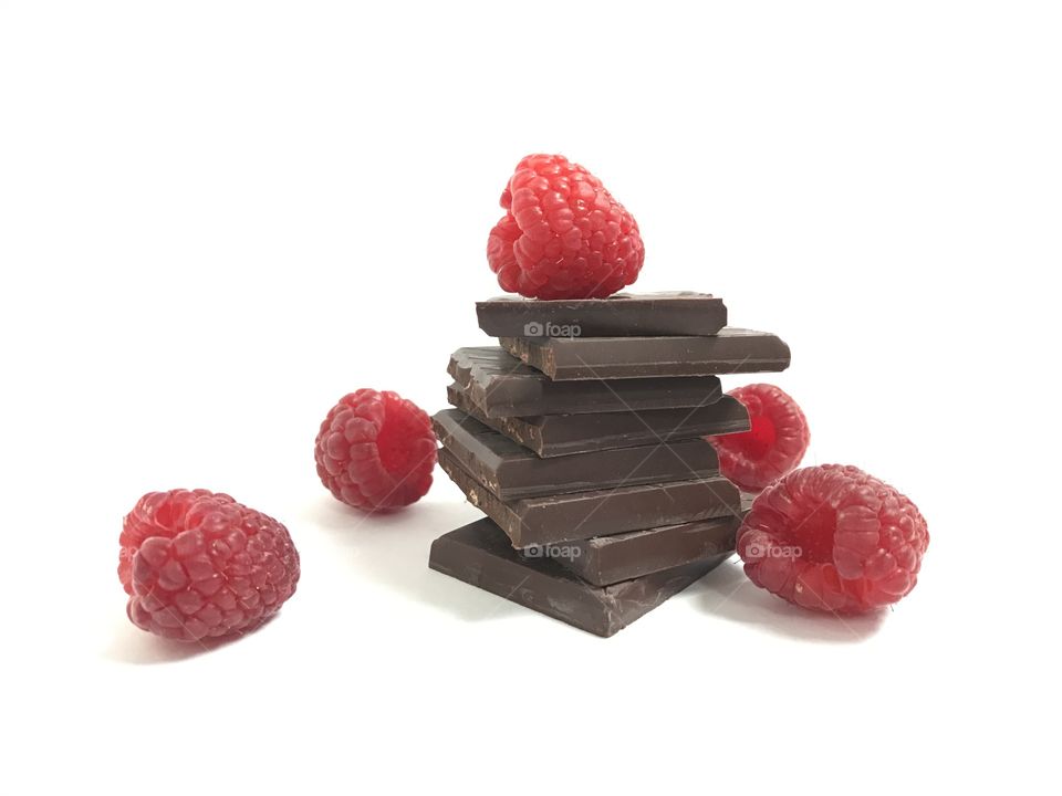 Pieces of chocolate and raspberries