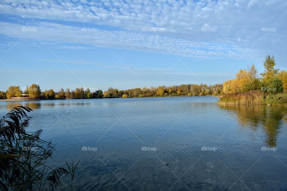 autumn beautiful landscape lake shore blue sky background