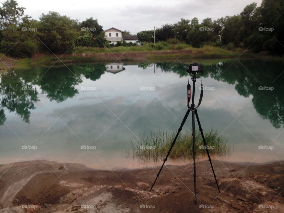 camera on tripod set for a long exposure shot of a landscape reflection