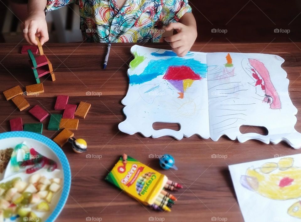 Four years old childcreatively picks his new domino and continues to paint his painting with love.He grows up with sincerity, but his playing desk remembers his childhood well, his energy,his joy, his laughs,his cries and his understanding of life..