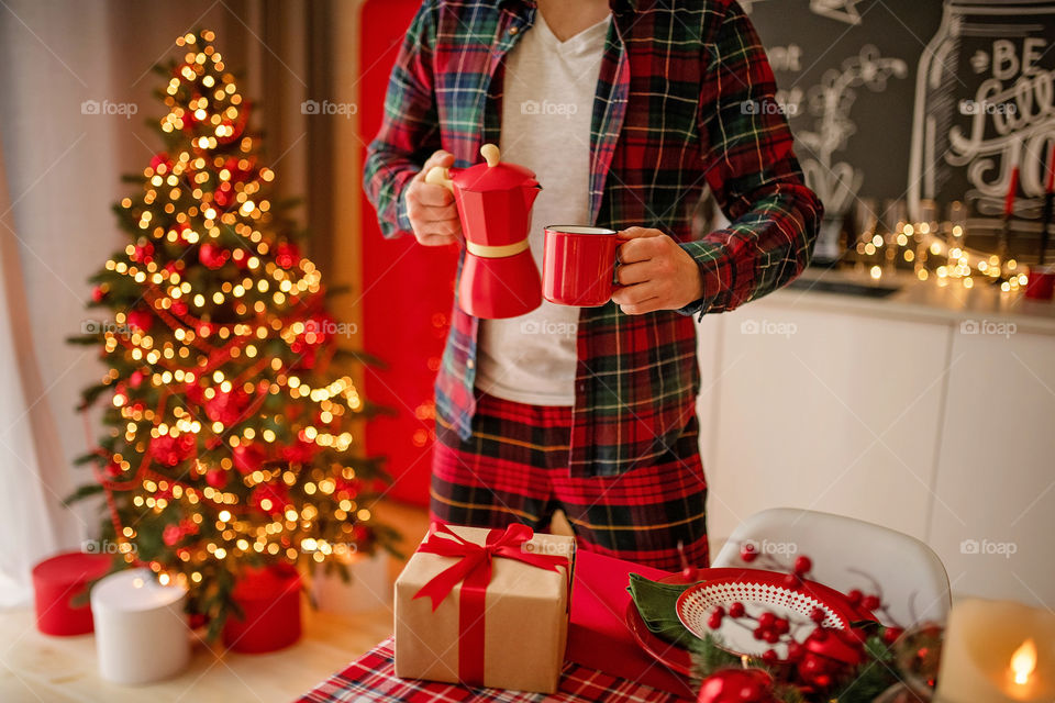 man sets a beautiful decorated winter table for a festive dinner.  Merry Christmas and Happy New Year.