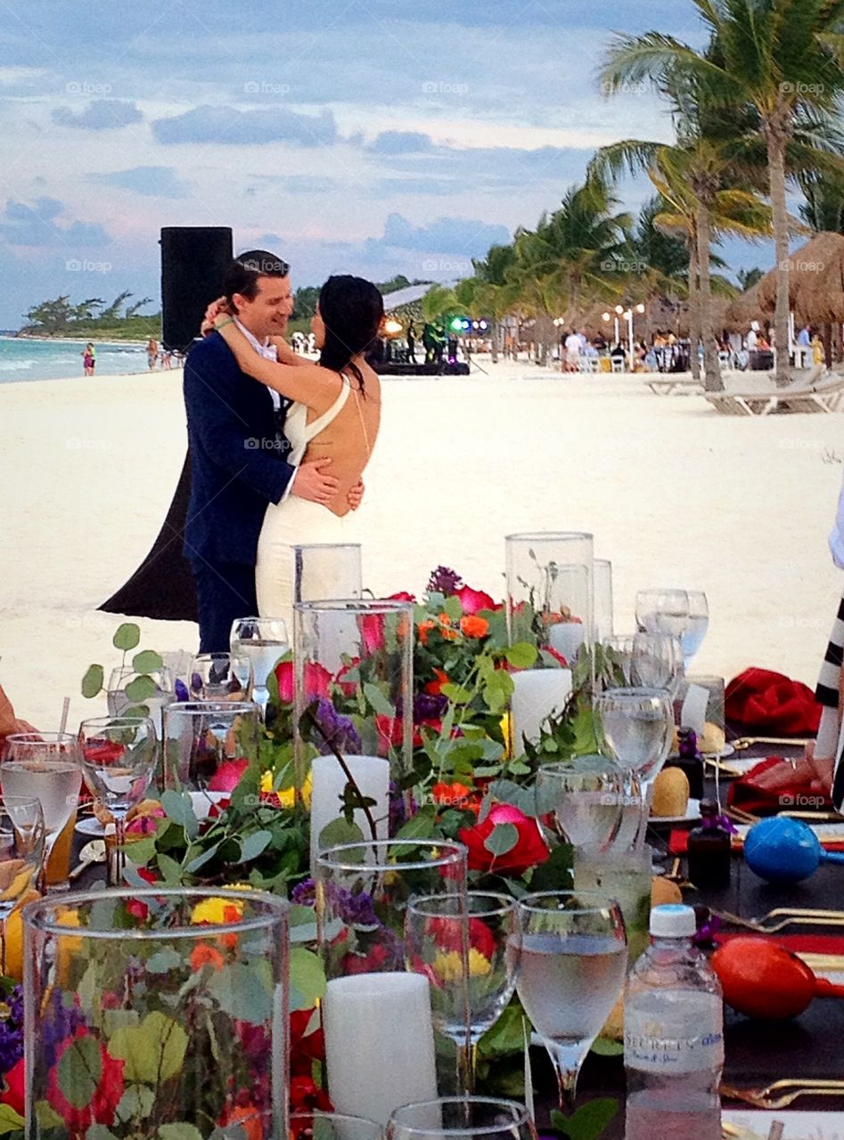 Couple standing at beach behind table