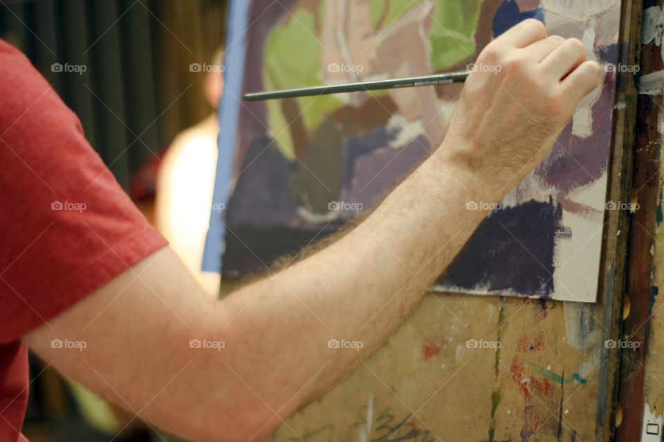 An artist paints in a studio