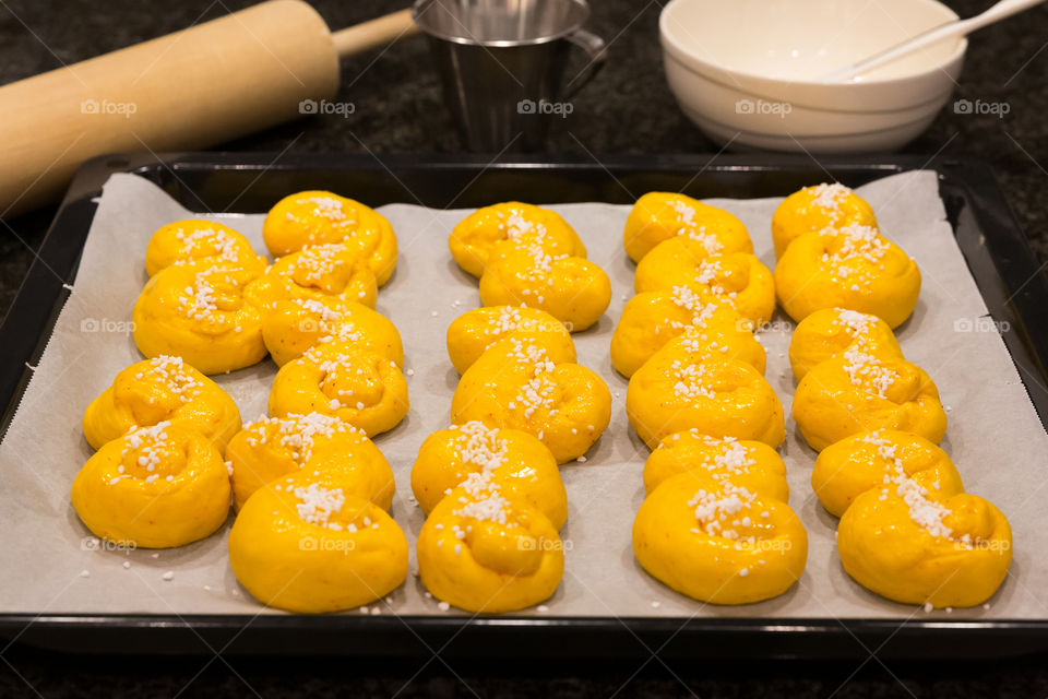 Baking saffron buns for Christmas, Swedish tradition 