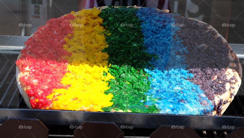 Rainbow pizza sold at a fair.