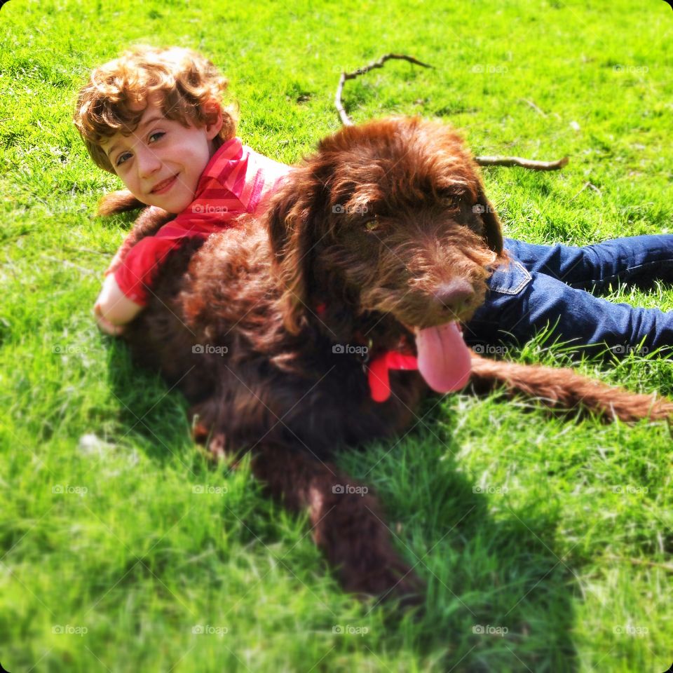 Five year old boy and his dog. Five year old boy playing with his pet Labradoodle dog