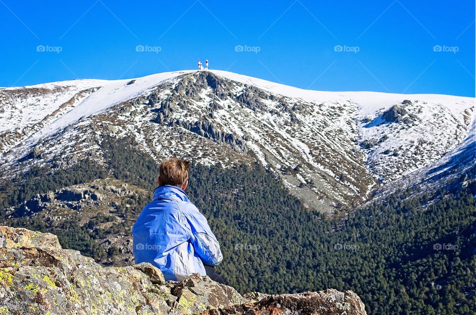 Woman looking at the snow capped mountain 