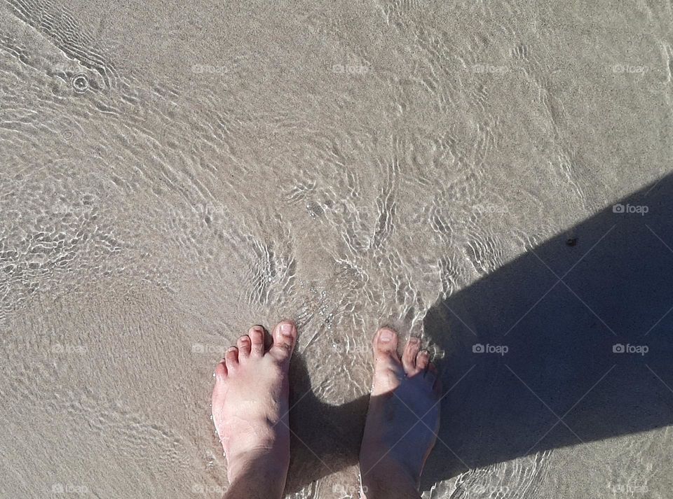 Feet in the ocean