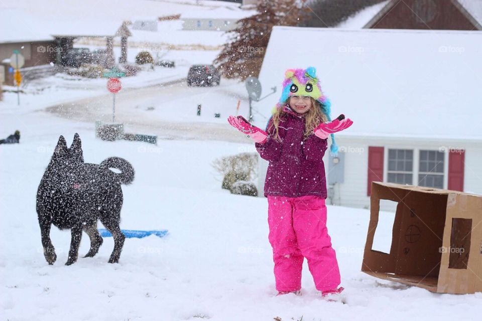 Husky and girl enjoying snow