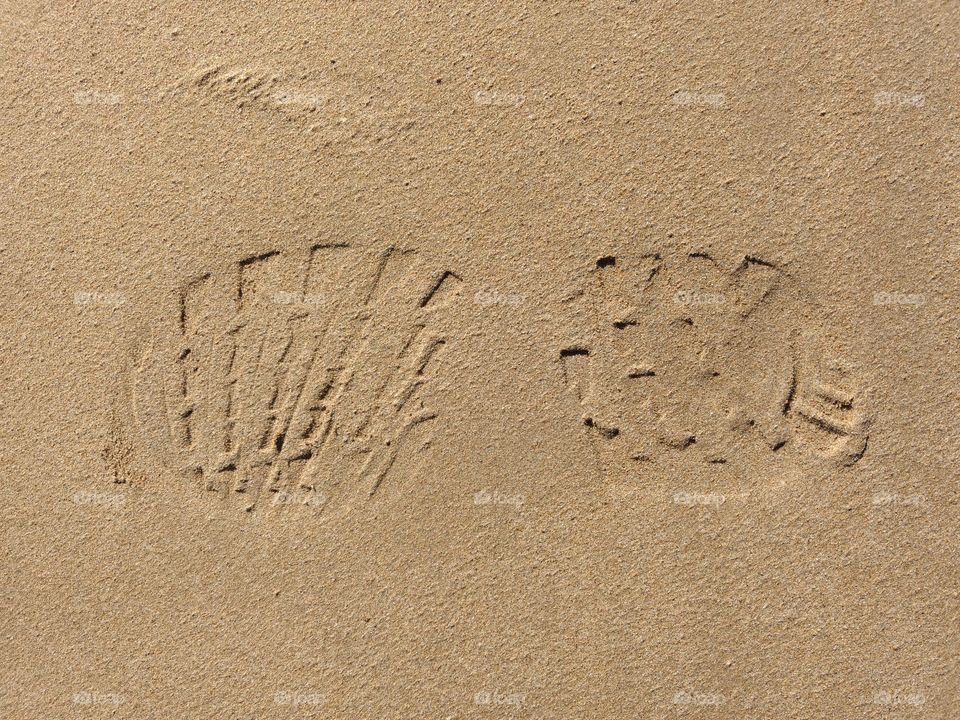 Footprint from shoe in sand.