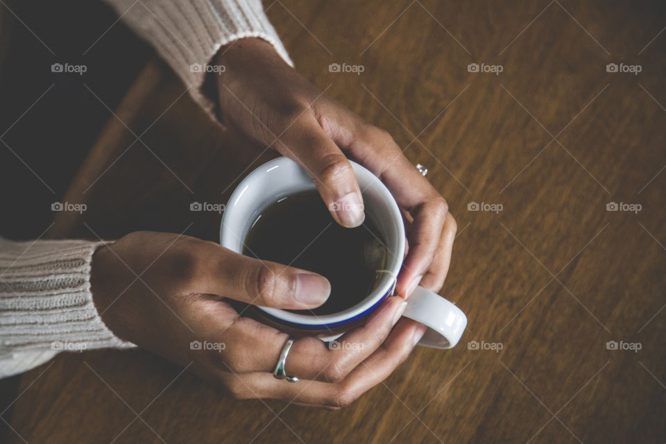 Hands holding a cup of tea