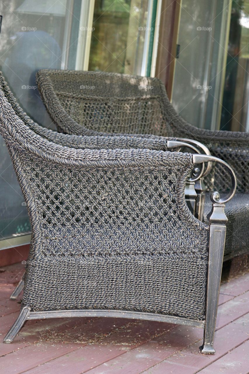 Grey wicker chair on porch