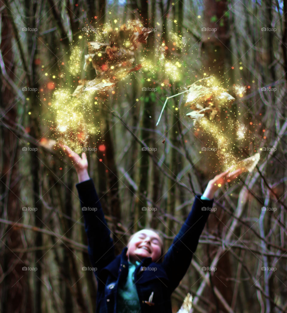 Girl throwing autumn leaf with glitters