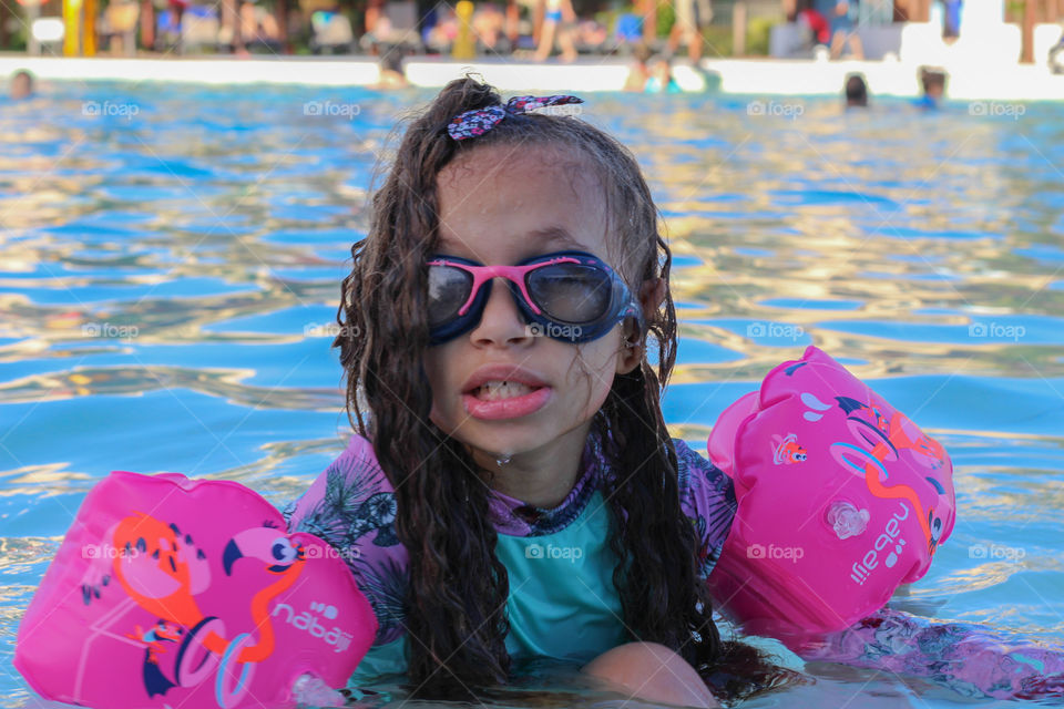 Little girl inside the pool (portrait)